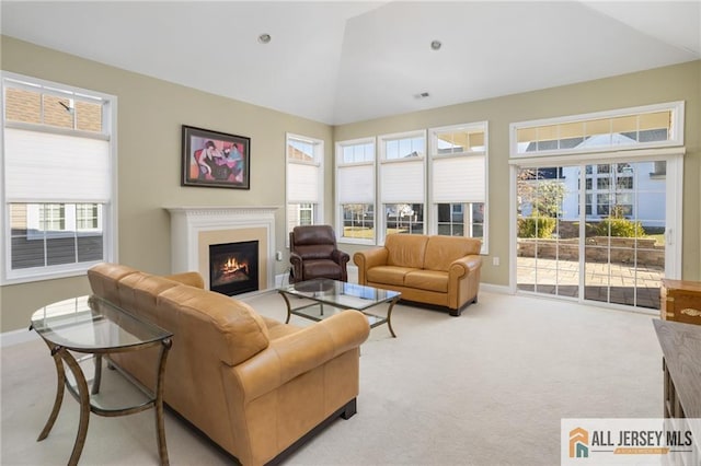 living room with vaulted ceiling and light carpet