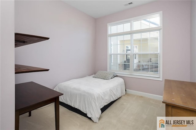 carpeted bedroom with visible vents and baseboards