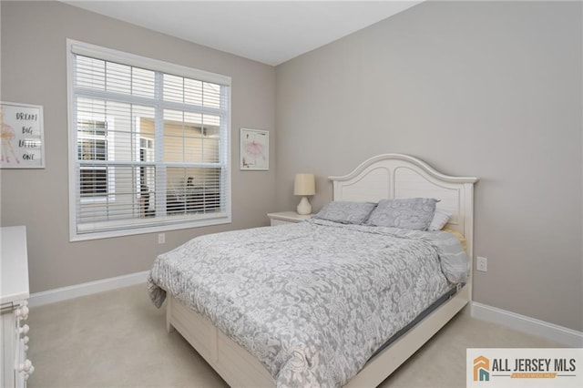 bedroom with light colored carpet