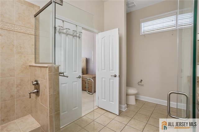 full bathroom with tile patterned flooring, baseboards, a shower stall, and toilet