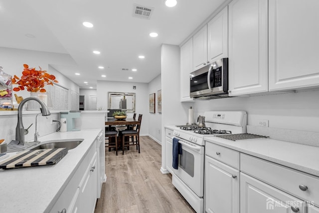 358 Rector St Unit 218, Perth Amboy, NJ 08861 - kitchen with recessed lighting, visible vents, a sink, stainless steel microwave, and white range with gas cooktop