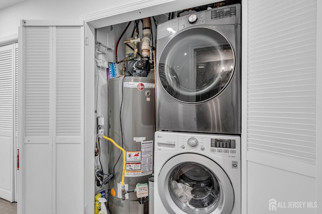358 Rector St Unit 218, Perth Amboy, NJ 08861 - clothes washing area featuring water heater, stacked washing maching and dryer, and laundry area