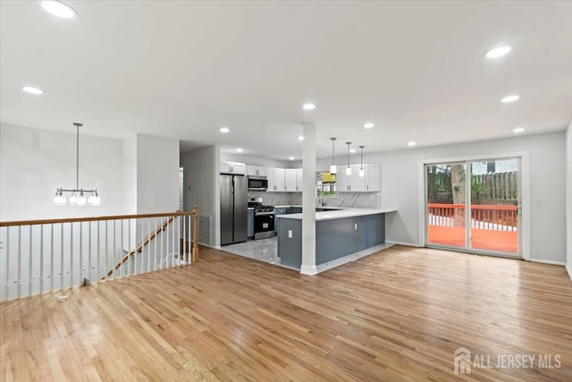 376 New Brunswick Ave, East Brunswick, NJ 08816 - kitchen with stainless steel appliances, light wood-type flooring, white cabinetry, a peninsula, and recessed lighting
