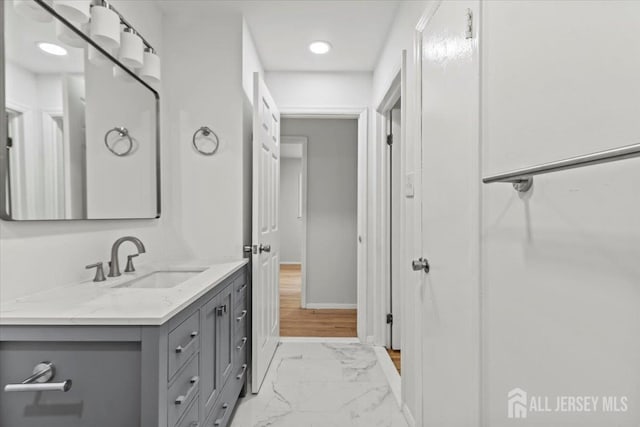 376 New Brunswick Ave, East Brunswick, NJ 08816 - bathroom featuring vanity, marble look tiles, and recessed lighting