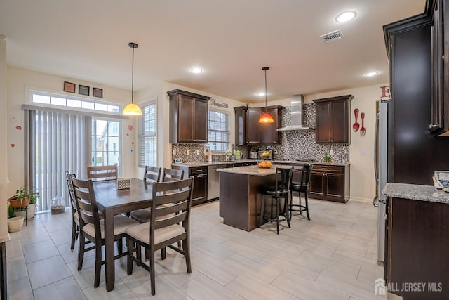 dining area with plenty of natural light and recessed lighting