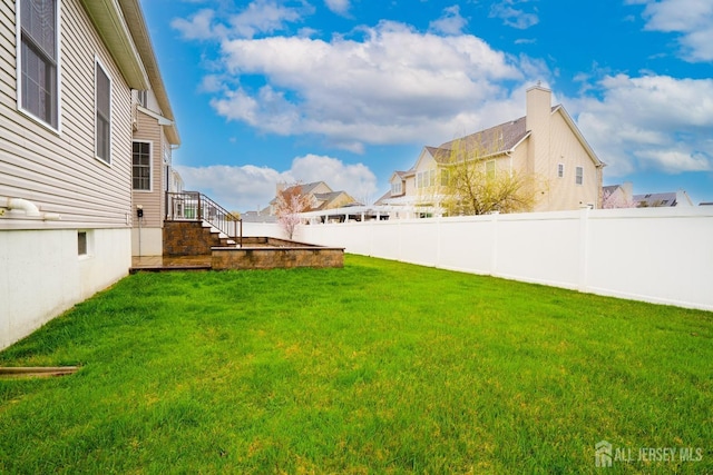 view of yard featuring a residential view and stairway