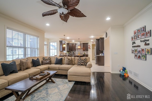 living room featuring a ceiling fan, dark wood finished floors, crown molding, baseboards, and recessed lighting