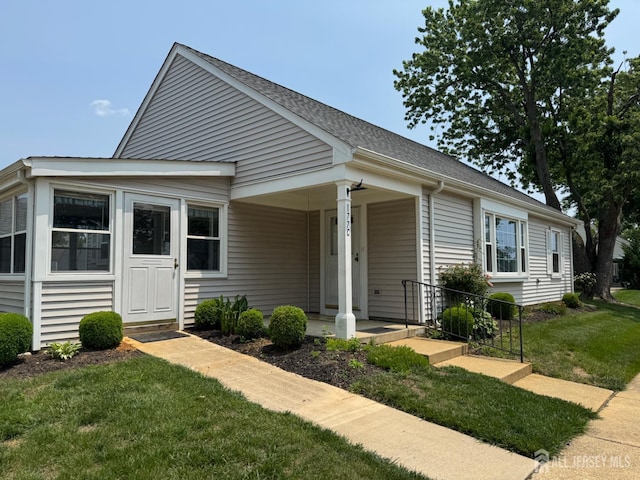 177-C Rossmoor Dr Unit 177C, Monroe, NJ 08831 - bungalow-style house featuring a front lawn, covered porch, and roof with shingles