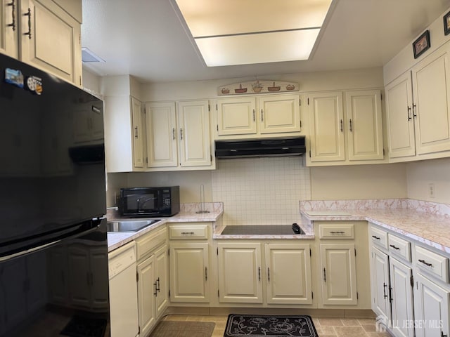 177-C Rossmoor Dr Unit 177C, Monroe, NJ 08831 - kitchen featuring black appliances, under cabinet range hood, light countertops, and backsplash