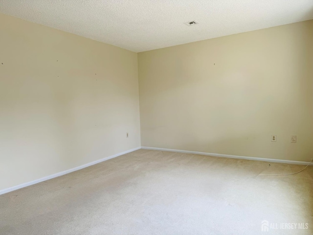 177-C Rossmoor Dr Unit 177C, Monroe, NJ 08831 - spare room with light carpet and baseboards