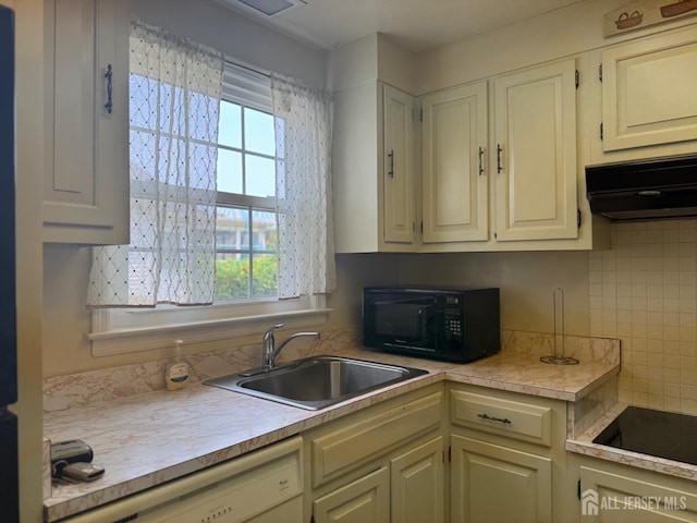 177-C Rossmoor Dr Unit 177C, Monroe, NJ 08831 - kitchen with black appliances, extractor fan, light countertops, and decorative backsplash