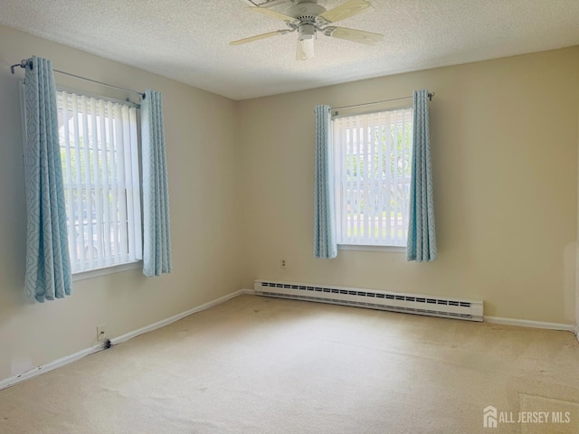 177-C Rossmoor Dr Unit 177C, Monroe, NJ 08831 - carpeted spare room with a baseboard radiator, healthy amount of natural light, ceiling fan, and a textured ceiling