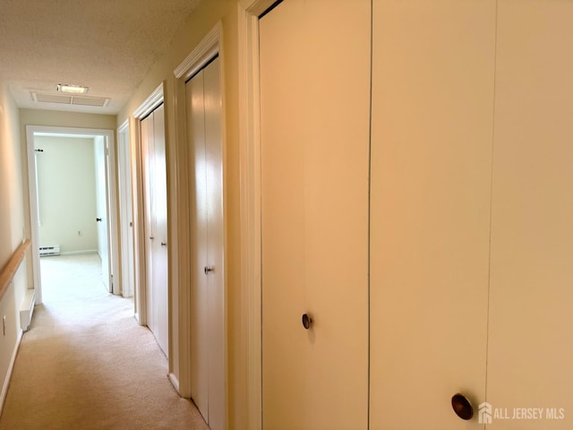 177-C Rossmoor Dr Unit 177C, Monroe, NJ 08831 - hallway with light carpet, a textured ceiling, and a baseboard radiator