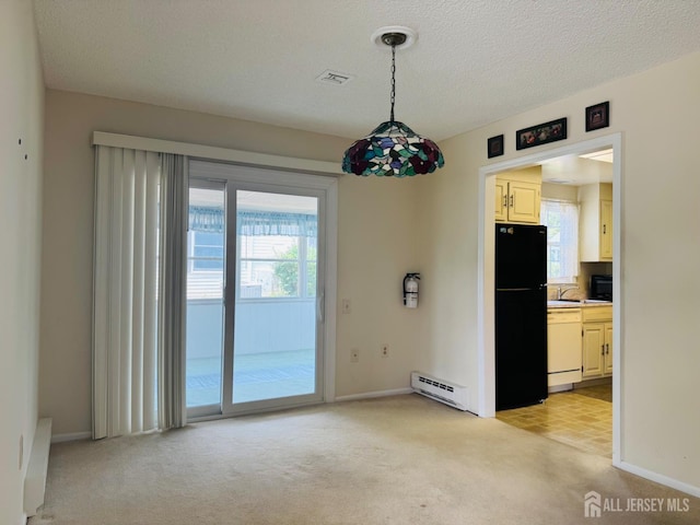 177-C Rossmoor Dr Unit 177C, Monroe, NJ 08831 - unfurnished dining area featuring a baseboard heating unit, light carpet, and a textured ceiling