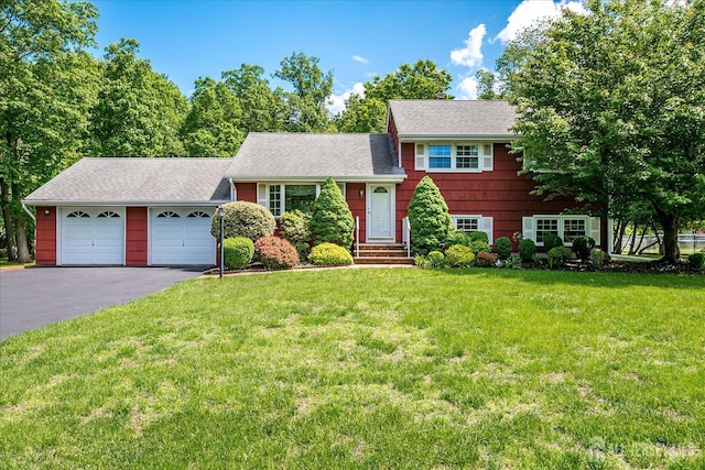 200 Elwood St, Piscataway, NJ 08854 - tri-level home featuring a garage, driveway, a front yard, and a shingled roof
