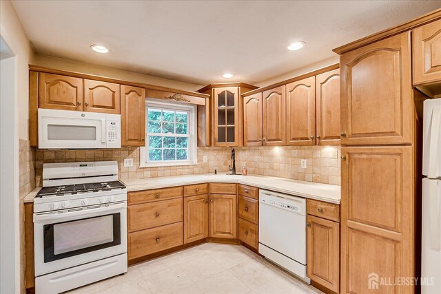 200 Elwood St, Piscataway, NJ 08854 - kitchen featuring white appliances, light countertops, a sink, glass insert cabinets, and decorative backsplash