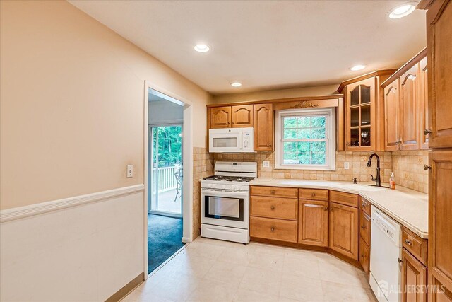 200 Elwood St, Piscataway, NJ 08854 - kitchen with white appliances, a sink, light countertops, glass insert cabinets, and tasteful backsplash