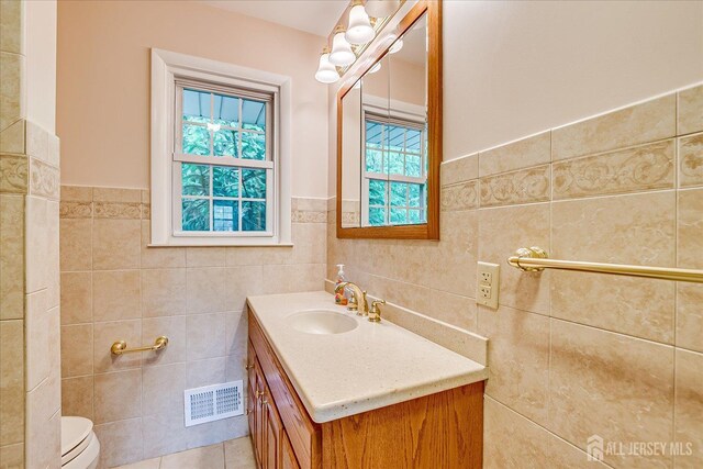 200 Elwood St, Piscataway, NJ 08854 - bathroom with tile walls, vanity, toilet, and wainscoting