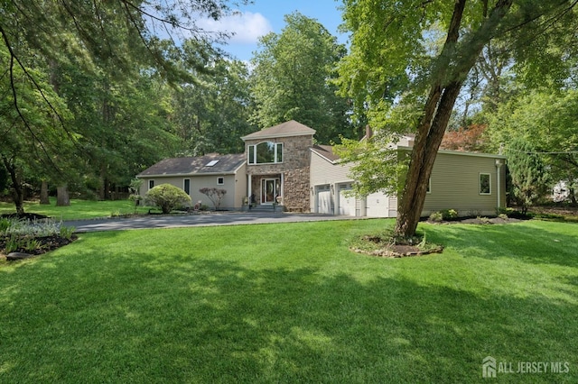 2 Derby Ln, East Brunswick, NJ 08816 - view of front of house featuring a front lawn, stone siding, driveway, and a garage