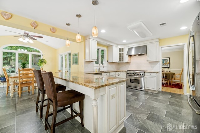 2 Derby Ln, East Brunswick, NJ 08816 - kitchen with stainless steel appliances, wall chimney exhaust hood, a peninsula, healthy amount of natural light, and recessed lighting