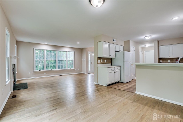 36 Benjamin Rush Ln, Princeton, NJ 08540 - kitchen with freestanding refrigerator, open floor plan, decorative backsplash, light wood-style flooring, and light countertops