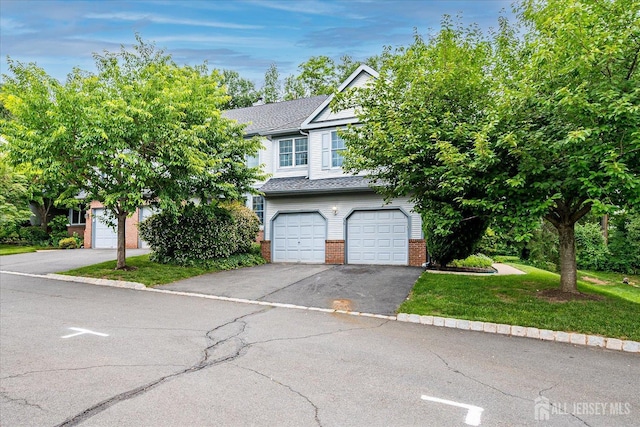 36 Benjamin Rush Ln, Princeton, NJ 08540 - view of front of house with asphalt driveway, brick siding, an attached garage, a front yard, and roof with shingles