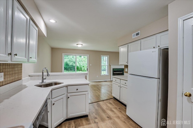 36 Benjamin Rush Ln, Princeton, NJ 08540 - kitchen with freestanding refrigerator, light countertops, a peninsula, light wood-type flooring, and recessed lighting