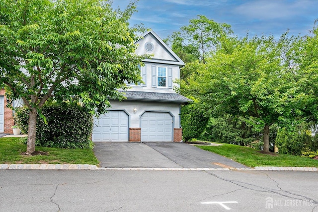 36 Benjamin Rush Ln, Princeton, NJ 08540 - view of front facade with driveway, brick siding, and a garage