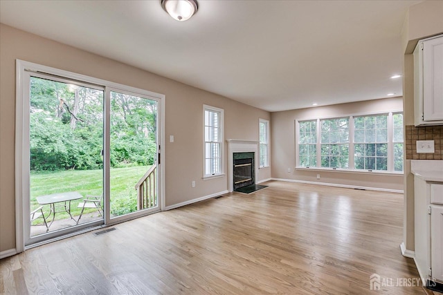36 Benjamin Rush Ln, Princeton, NJ 08540 - unfurnished living room with light wood-style flooring, a premium fireplace, and recessed lighting