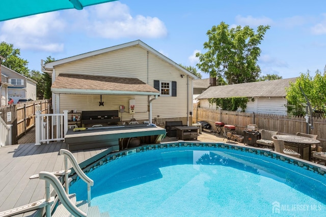16 Taft Ave, Edison, NJ 08817 - view of pool featuring a wooden deck, a fenced backyard, and an outdoor living space with a fire pit