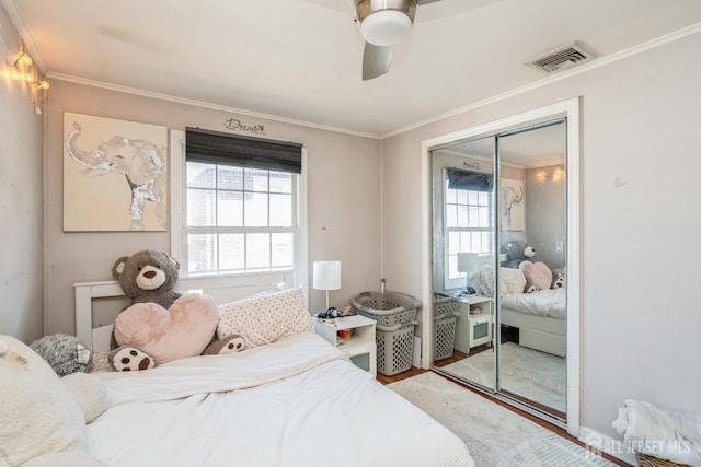 16 Taft Ave, Edison, NJ 08817 - bedroom featuring multiple windows, crown molding, wood finished floors, a closet, and a ceiling fan