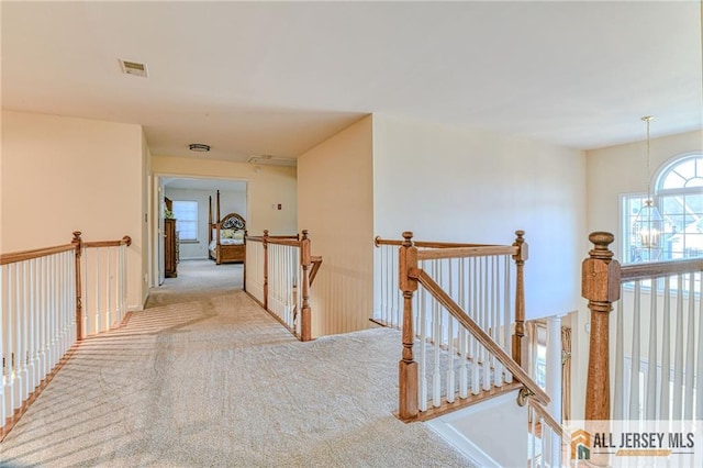 2 Kristen Ct, Franklin, NJ 08873 - hall featuring an upstairs landing, carpet, and a chandelier