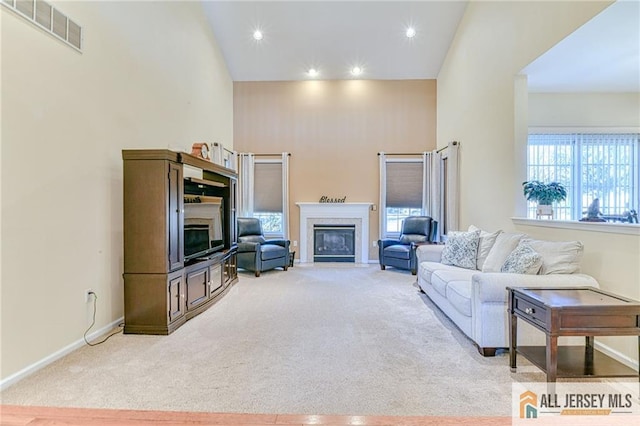 2 Kristen Ct, Franklin, NJ 08873 - carpeted living area with a fireplace with flush hearth, baseboards, recessed lighting, and a high ceiling