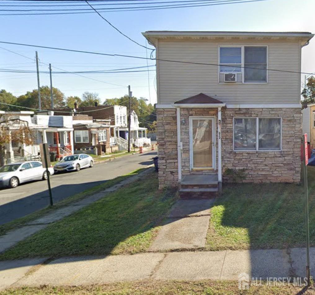 852 Kreil St, Perth Amboy, NJ 08861 - view of property featuring stone siding and a front lawn