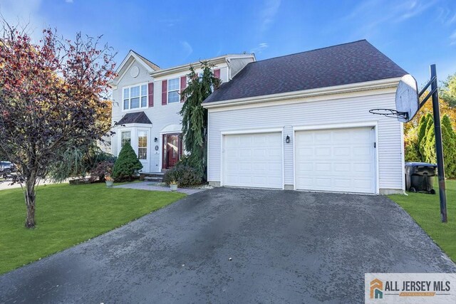 view of front facade featuring a front lawn and a garage