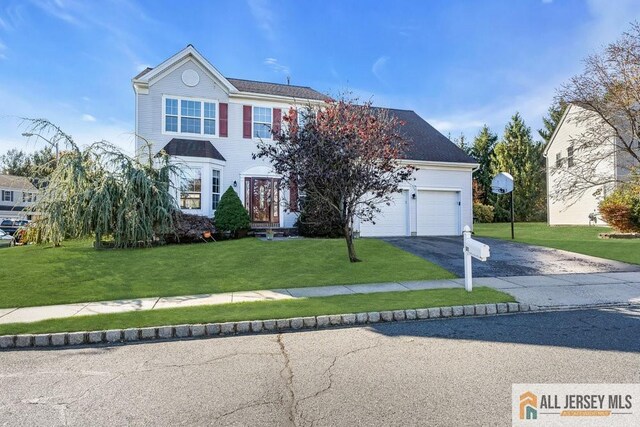 view of front facade with a front yard and a garage