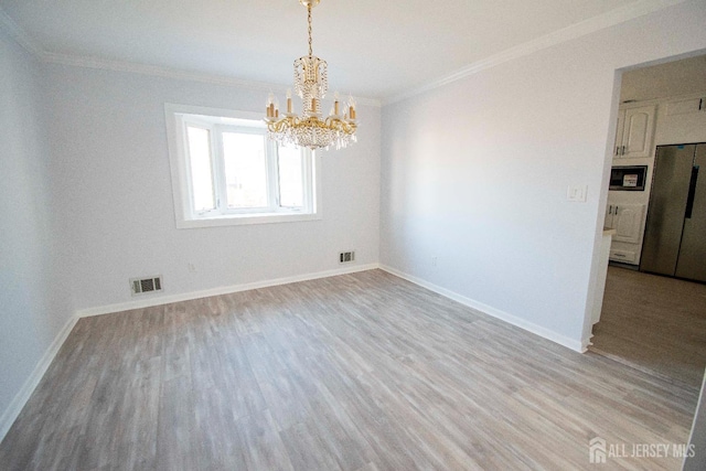 unfurnished dining area with crown molding, visible vents, and light wood finished floors