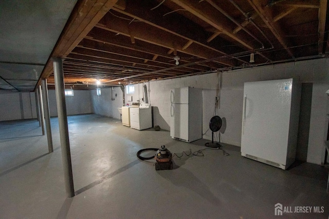 basement with freestanding refrigerator and separate washer and dryer