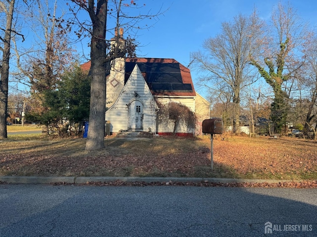 tudor house featuring a chimney