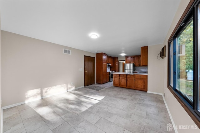 39 Miara St, Sayreville, NJ 08859 - kitchen with freestanding refrigerator, light countertops, brown cabinetry, wall oven, and a peninsula