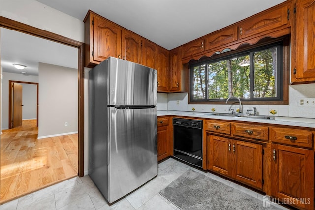 39 Miara St, Sayreville, NJ 08859 - kitchen with freestanding refrigerator, dishwasher, brown cabinetry, light countertops, and decorative backsplash