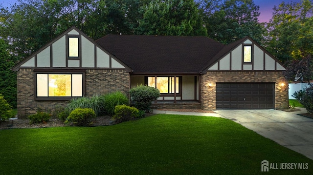 39 Miara St, Sayreville, NJ 08859 - tudor house with brick siding, driveway, an attached garage, a front lawn, and stucco siding