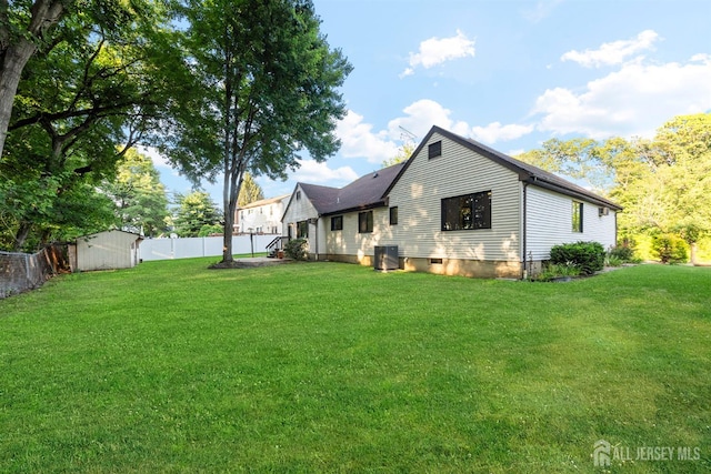 39 Miara St, Sayreville, NJ 08859 - back of house featuring a storage shed and a fenced backyard