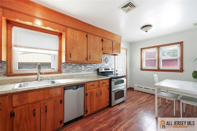 49 Paul St, Fords, NJ 08863 - kitchen with appliances with stainless steel finishes, light countertops, tasteful backsplash, dark wood-style floors, and a baseboard heating unit