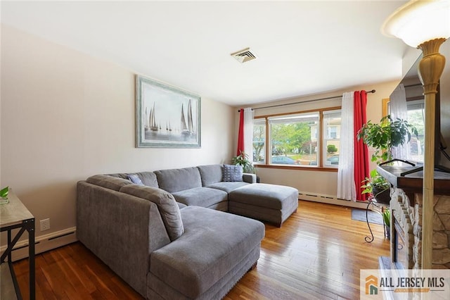 49 Paul St, Fords, NJ 08863 - living area with baseboard heating and wood finished floors