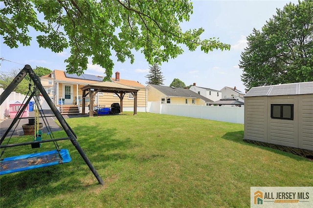 49 Paul St, Fords, NJ 08863 - fenced backyard with a gazebo, a shed, and a playground