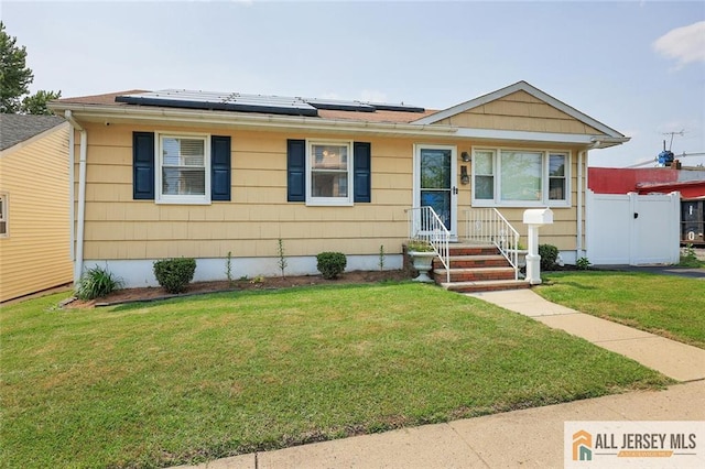 49 Paul St, Fords, NJ 08863 - view of front facade featuring solar panels and a gate