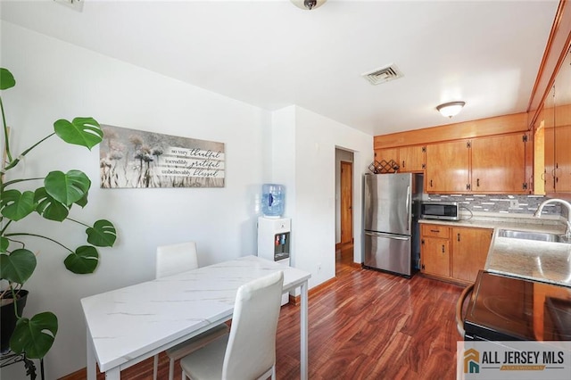 49 Paul St, Fords, NJ 08863 - kitchen with stainless steel appliances, dark wood finished floors, and tasteful backsplash