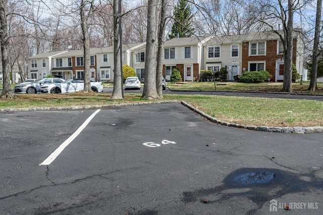 uncovered parking lot with a residential view