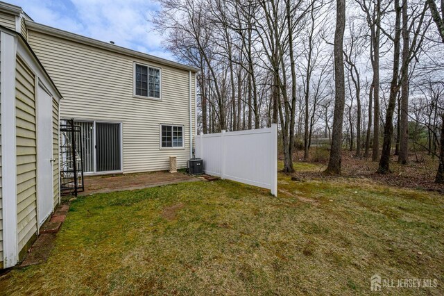 view of yard with fence and cooling unit